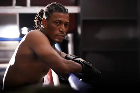 I only know the ring. Portrait of a young boxer leaning on the ropes of a boxing Fotos de archivo