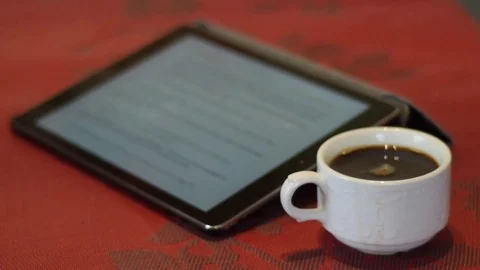 I-pad with full white cup of coffee Stock Footage 74570412