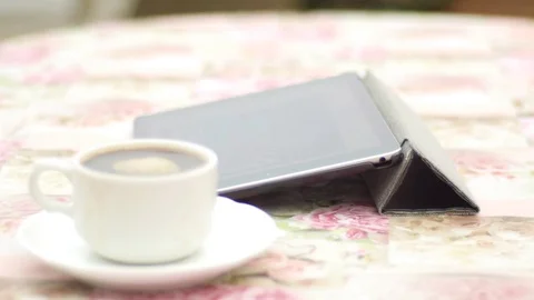 I-pad with white cup of coffee on a saucer Stock Footage 74570480