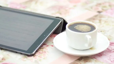 I-pad with white cup of coffee on a saucer Stock Footage 74570486