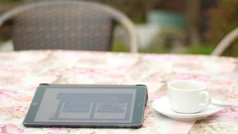 I-pad with white cup of coffee on a saucer Stock Footage 74570498