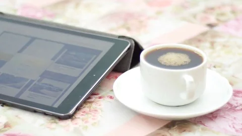I-pad with white cup of coffee on a saucer Stock Footage 74570509