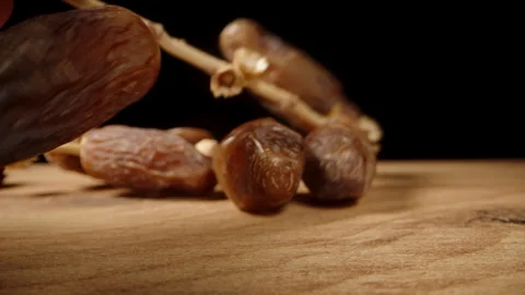 I pick up the dates from the table. Dolly slider extreme close-up. Stock Footage 244863228