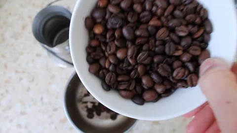 I pour the coffee beans into the coffee grinder 動画素材 155144689