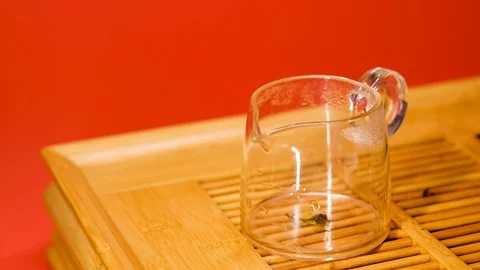 I pour tea from an earthenware teapot into bowls. Stock Footage 127441272
