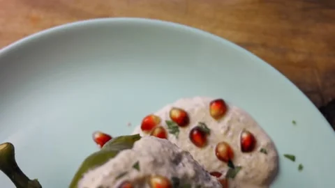 I prepare Mexican Stuffed Poblano Peppers in Walnut Sauce. 4k video Stock Footage 157785497