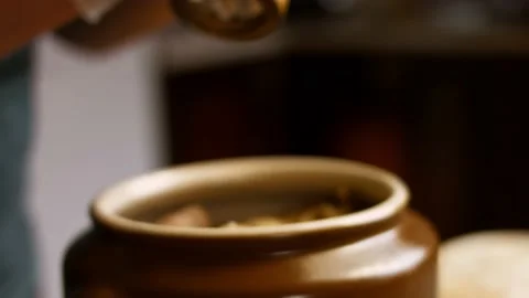 I press black pepper over the chickpea duck. The duck gives steam and looks very Stock Footage 156449028
