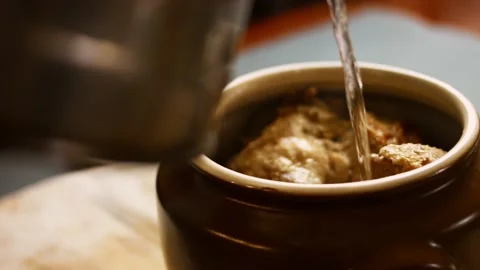 I press water over the chickpea duck. The duck gives steam and looks very Stock Footage 156449022