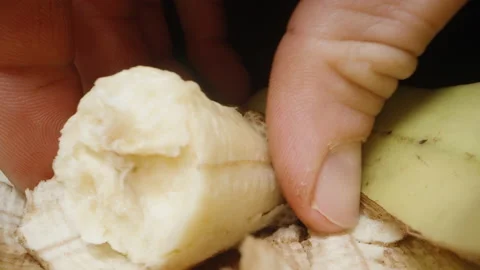I pull out a piece of banana from the peel and the camera goes inside. Dolly sli Stock Footage 231592139