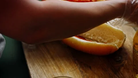 I put the BBQ Bruts sauce over the hot dog bread. 4k homemade video Stock Footage 159508468