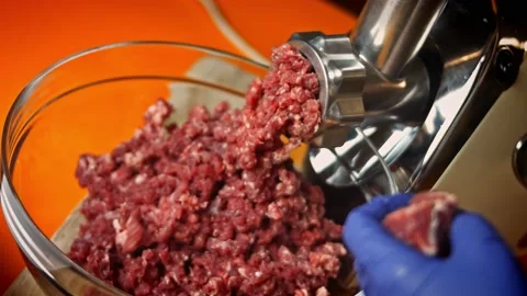 I put the beef in the meat grinder. Falscher Hase recipe. 4k video recipe Stock Footage 156763466