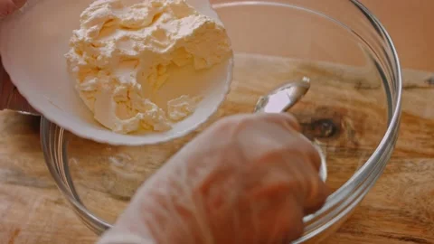 I put the cream cheese in the transparent bowl. 4k video Stock Footage 157789763
