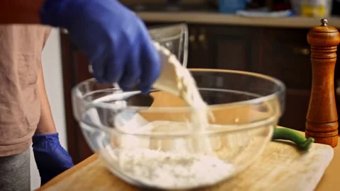 I put a cup of flour in a transparent bowl. 4k video Stock Footage 157284675