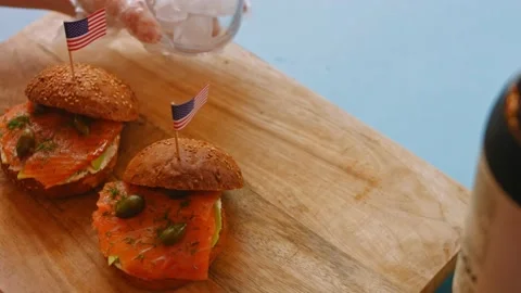 I put the glass of ice on the table. Smoked Salmon Bagel. 4k video Stock Footage 164425786