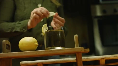 I put slices of lemon on the glass of juice Stock Footage 165065663