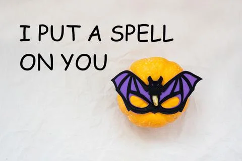I put a spell on you, text with pumpkin in bat mask Stock Photos