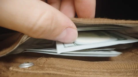 I put a stack of one hundred dollar bills in the pocket of my brown jeans. Dolly Stock Footage 247992522