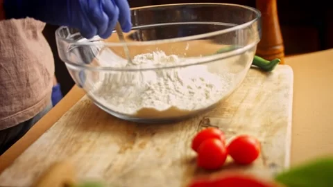 I put a tablespoon of salt over the flour. 4k video Stock Footage 157284938