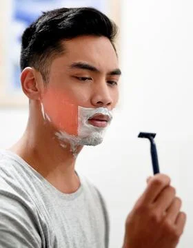 I really need to replace this. Shot of a young man at home getting razor burn Stock Photos