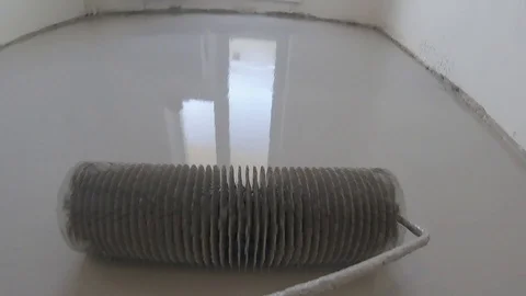 I roll out the self-leveling bulk floor Stock Footage 123817489