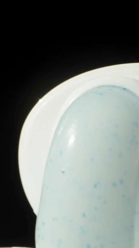 I squeeze out white toothpaste on a black background. Dolly slider extreme close Stock Footage 251632175