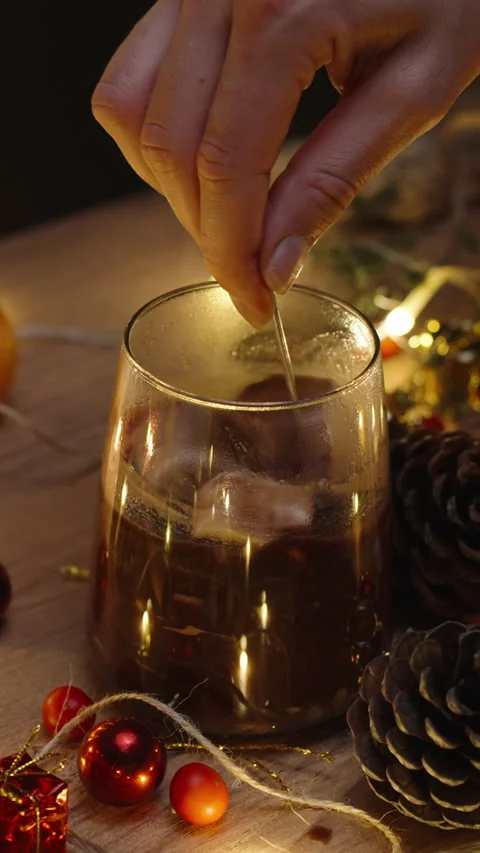 I stir marshmallows in cocoa, hot chocolate. Christmas table with candles and de Stock Footage 249039153