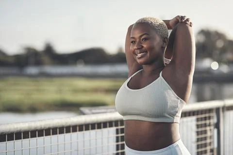 I stretch because it makes me feel good. an attractive young woman stretching Photos