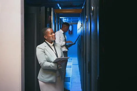 I think I fixed it. two young IT specialists standing together in the server Stock Photos