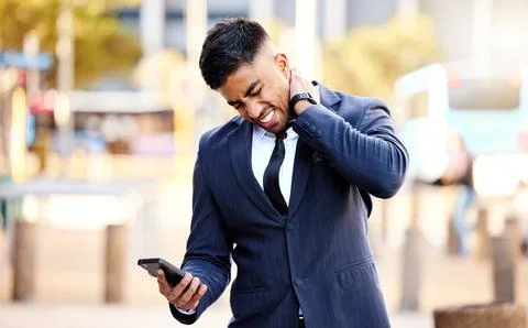 I think i just pulled a muscle. a young businessman massaging his neck in pain. Stock Photos