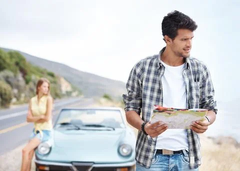 I think we took a wrong turn somewhere...Handsome young guy trying to find his Stock Photos