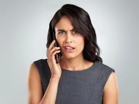 I think you have the wrong number. a young woman talking on her cellphone while Stock Photos
