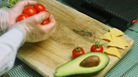 I throw more tomatoes on the table. I cook them for the grill Stock Footage 169355475