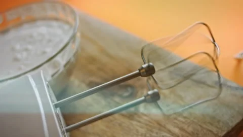 I turn on the hand mixer. 4k video Stock Footage 160554562