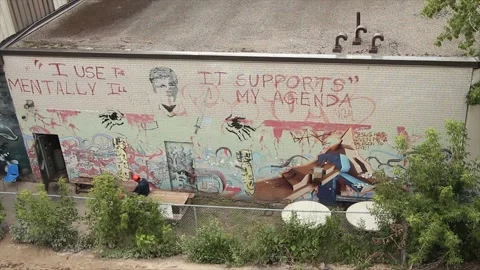 I use the mentally ill it supports my agenda written caption text on building Stock Footage 247753994