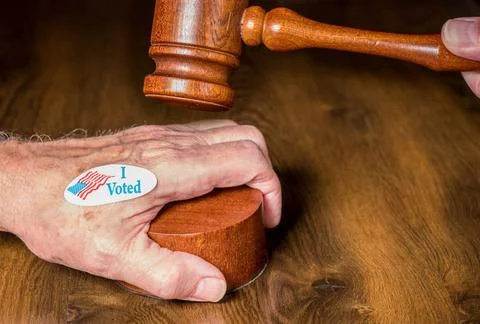 I voted campaign button or sticker on hand with a gavel and mallet to illu... Stock Photos
