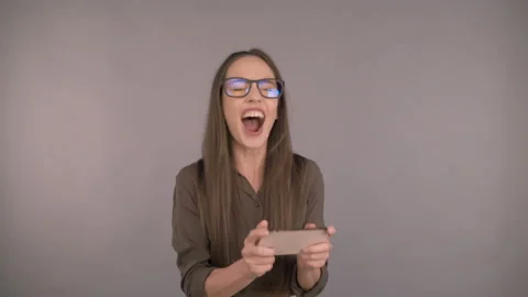 I won. Smiling long-haired, business woman middle age on an isolated yellow Stock Footage 162271725