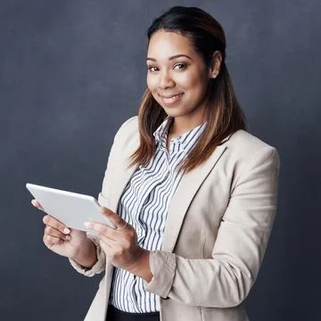I wont be able to do business without my tablet. Studio shot of a young Stock Photos