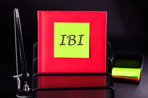 IBI (Inter beat Interval) written on a yellow sticker on a red notepad in fro Stock Photos