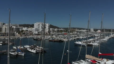 Ibiza Package 106 | low angle aerial drone city buildings mountain yachts ocean Video stock 117349690