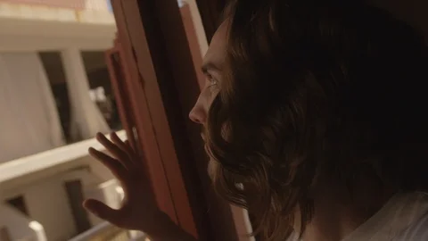 Ibiza Package 24 | man guy boy with long hair looking out the window Stock Footage 118660833