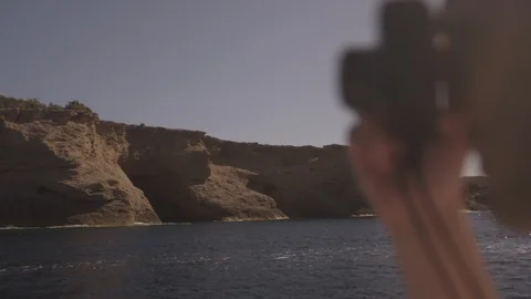 Ibiza Package 69 | man taking photos with camera on boat mountains ocean sea Stock Footage 118709874