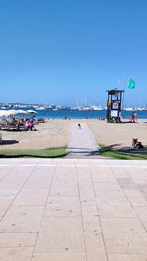 Ibiza, Spain - August 25, 2023: Child playing on the beach with sand in sun Stock Footage 313637962