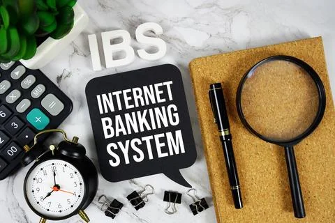 IBS - Internet Banking System acronym with calculator, alarm clock and magn.. Stock Photos