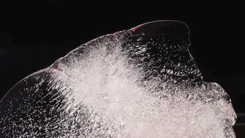 Ice with air bubbles illuminated with colored light Stock Footage 135879142