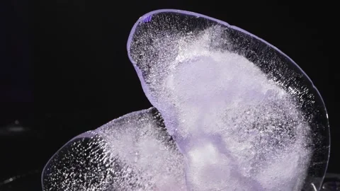 Ice with air bubbles illuminated with colored light 库存影片 135879289