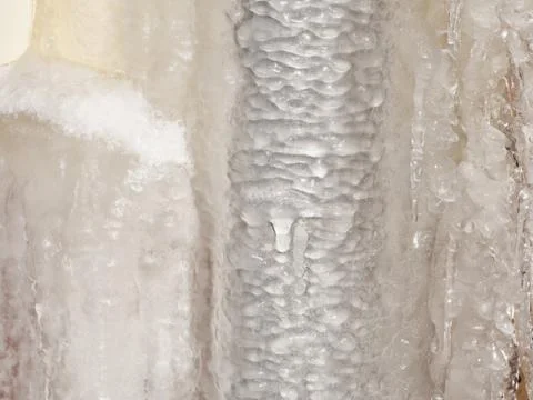 Ice and icicles on a drainpipe. Drainpipe covered with ice and icicles. Stock Photos