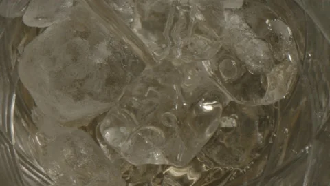 Ice and liquid being poured into cup Stock Footage