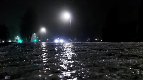 Ice and reflection on the sidewalk at night in winter. Reflection of street Stock Footage 296580822