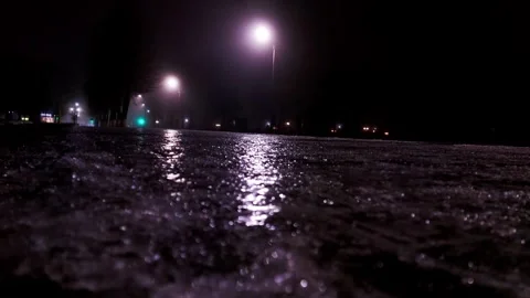 Ice and reflection on the sidewalk at night in winter. Reflection of street Stock Footage 312596887