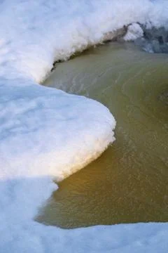 Ice and snow patterns in the stream Stock Photos